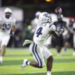 
              Utah State running back Calvin Tyler Jr. (4) makes a catch, going on to score a touchdown in the second quarter of the team's NCAA college football game against Hawaii, Saturday, Nov. 12, 2022, in Honolulu. (AP Photo/Marco Garcia)
            