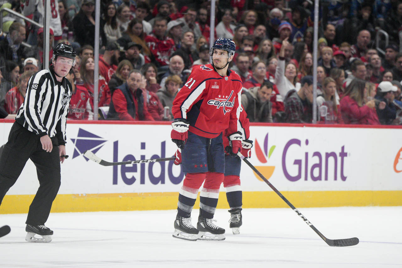 Washington Capitals right wing Garnet Hathaway (21) is escorted to the penalty box during the secon...