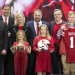 
              Back row from left, University of Nebraska president Ted Carter, Nebraska athletic director Trev Alberts, Julie Rhule, new Nebraska NCAA college football coach Matt Rhule and University of Nebraska-Lincoln chancellor Ronnie Green pose for photos along with Rhule's children, front from left, Leona, 7, Vivienne, 9, and Bryant, 18, following an introductory press conference, Monday, Nov. 28, 2022, in Lincoln, Neb. (AP Photo/Rebecca S. Gratz)
            