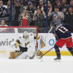 
              Vegas Golden Knights' Logan Thompson, left, makes a save against Columbus Blue Jackets' Johnny Gaudreau, right, during the shootout period of an NHL hockey game on Monday, Nov. 28, 2022, in Columbus, Ohio. (AP Photo/Jay LaPrete)
            