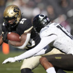 
              Colorado running back Deion Smith, left, is tackled after a short gain by Oregon defensive back Bryan Addison in the first half of an NCAA college football game, Saturday, Nov. 5, 2022, in Boulder, Colo. (AP Photo/David Zalubowski)
            