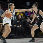 
              Iowa guard Gabbie Marshall, left, dribbles towards UConn forward Lou Lopez-Senechal during the first half of an NCAA college basketball game in the Phil Knight Legacy Championship in Portland, Ore., Sunday, Nov. 27, 2022. (AP Photo/Craig Mitchelldyer)
            