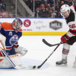 
              New Jersey Devils' Erik Haula (56) is stopped by Edmonton Oilers goalie Stuart Skinner (74) during the third period of an NHL hockey game Thursday, Nov. 3, 2022, in Edmonton, Alberta. (Jason Franson/The Canadian Press via AP)
            