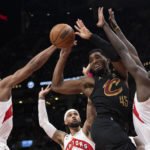 
              Cleveland Cavaliers' Donovan Mitchell (45) looks to lay off a pass after being boxed out by the Toronto Raptors defense during second-half NBA basketball game action in Toronto, Monday, Nov. 28, 2022. (Chris Young/The Canadian Press via AP)
            