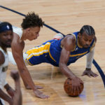 
              Golden State Warriors guard Ryan Rollins dives for the ball against New Orleans Pelicans guard Dyson Daniels in the second half of an NBA basketball game in New Orleans, Monday, Nov. 21, 2022. The Pelicans won 128-83. (AP Photo/Gerald Herbert)
            