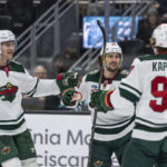 
              Minnesota Wild forward Mats Zuccarello, center, is congratulated by defenseman Jon Merrill, left, and forward Kirill Kaprizov for his goal during the first period of the team's NHL hockey game against the Seattle Kraken, Friday, Nov. 11, 2022, in Seattle. (AP Photo/Stephen Brashear)
            