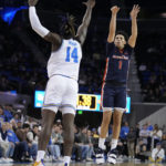 
              Pepperdine guard Mike Mitchell Jr. (1) shoots over UCLA forward Kenneth Nwuba (14) during the first half of an NCAA college basketball game Wednesday, Nov. 23, 2022, in Los Angeles. (AP Photo/Marcio Jose Sanchez)
            
