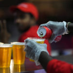 
              FILE - Staff member pours a beer at a fan zone ahead of the FIFA World Cup, in Doha, Qatar Saturday, Nov. 19, 2022. The last-minute decision to ban the sale of beer at World Cup stadiums in Qatar is the latest example of some the tensions that have played out ahead of the tournament. Qatari officials have for long said they were eager to welcome everybody but that visitors should also respect their culture and traditions. (AP Photo/Petr Josek)
            