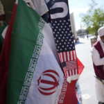 
              An Iranian flag and a scarf depicting U.S. flag are sold at the Souq Waqif Market in Doha, Qatar, Tuesday, Nov. 29, 2022. (AP Photo/Eugene Hoshiko)
            
