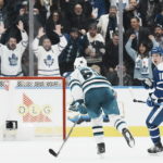 
              Toronto Maple Leafs' Mitchell Marner, right, turns to celebrate after scoring an empty-net goal against the San Jose Sharks during the third period of an NHL hockey game Wednesday, Nov. 30, 2022, in Toronto. (Chris Young/The Canadian Press via AP)
            