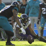 
              Baltimore Ravens cornerback Marcus Peters (24) recovers a fumble thrown by Jacksonville Jaguars quarterback Trevor Lawrence (16) during the second half of an NFL football game, Sunday, Nov. 27, 2022, in Jacksonville, Fla. (AP Photo/Phelan M. Ebenhack)
            