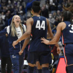 
              Connecticut's Paige Bueckers, left, reacts toward her team during the first half of an NCAA collage basketball game against North Carolina State, Sunday, Nov. 20, 2022, in Hartford, Conn. (AP Photo/Jessica Hill)
            