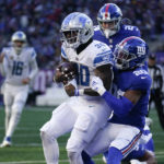 
              Detroit Lions running back Jamaal Williams (30) scores a touchdown against New York Giants safety Julian Love (20) during the second half of an NFL football game, Sunday, Nov. 20, 2022, in East Rutherford, N.J. (AP Photo/Seth Wenig)
            