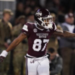 
              Mississippi State wide receiver Zavion Thomas (87) celebrates his return of a punt 63-yards for a touchdown during the first half of an NCAA college football game against Georgia in Starkville, Miss., Saturday, Nov. 12 2022. (AP Photo/Rogelio V. Solis)
            