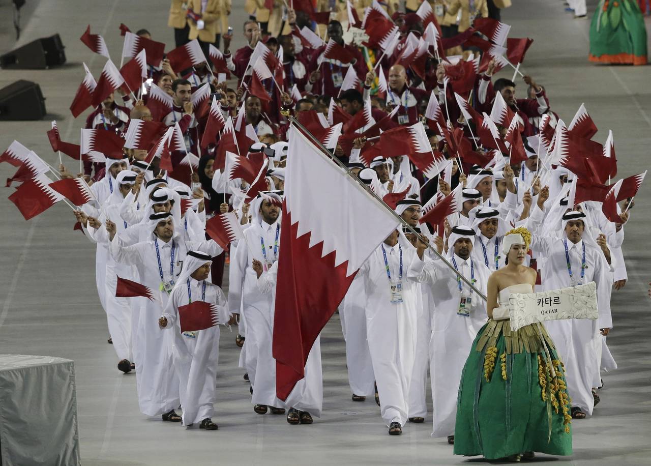 FILE - Athletes from Qatar march into the stadium during the opening ceremony for the 17th Asian Ga...