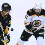 
              Pittsburgh Penguins' Pierre-Olivier Joseph (73) and Boston Bruins' Nick Foligno (17) try to control the puck during the first period of an NHL hockey game Tuesday, Nov. 1, 2022, in Pittsburgh. (AP Photo/Keith Srakocic)
            