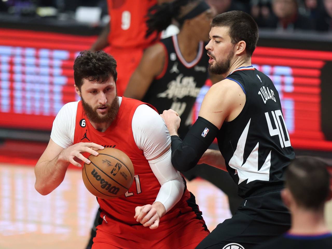 Portland Trail Blazers center Jusuf Nurkic, left, makes a move under the basket against Los Angeles...
