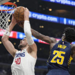 
              Los Angeles Clippers center Ivica Zubac, left, grabs a rebound away from Indiana Pacers forward Jalen Smith during the second half of an NBA basketball game Sunday, Nov. 27, 2022, in Los Angeles. (AP Photo/Mark J. Terrill)
            