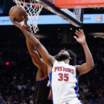 
              Phoenix Suns' Bismack Biyombo, left, tips the ball off the fingers of Detroit Pistons' Marvin Bagley III (35) during the first half of an NBA basketball game in Phoenix, Friday, Nov. 25, 2022. (AP Photo/Darryl Webb)
            