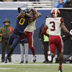 
              Oklahoma defensive back Woodi Washington, behind, breaks up a pass intended for West Virginia wide receiver Bryce Ford-Wheaton (0) during the second half of an NCAA college football game in Morgantown, W.Va., Saturday, Nov. 12, 2022. (AP Photo/Kathleen Batten)
            