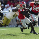 
              Georgia running back Daijun Edwards (30) is brought down from behind by Georgia Tech defensive lineman Zeek Biggers (88) during the first half of an NCAA college football game Saturday, Nov. 26, 2022 in Athens, Ga. (AP Photo/John Bazemore)
            