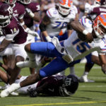 
              Florida quarterback Anthony Richardson (15) dives past Texas A&M defensive back Jacoby Mathews (14) for a touchdown during the first quarter of an NCAA college football game Saturday, Nov. 5, 2022, in College Station, Texas. (AP Photo/Sam Craft)
            