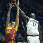 
              California forward Kuany Kuany (13) and Southern California guard Tre White (22) compete for a rebound during the first half of an NCAA college basketball game in Berkeley, Calif., Wednesday, Nov. 30, 2022. (AP Photo/Godofredo A. Vásquez)
            