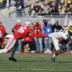 
              Michigan receiver Cornelius Johnson, right, escapes the grasp of Ohio State defensive back Cameron Brown during the first half of an NCAA college football game on Saturday, Nov. 26, 2022, in Columbus, Ohio. (AP Photo/Jay LaPrete)
            