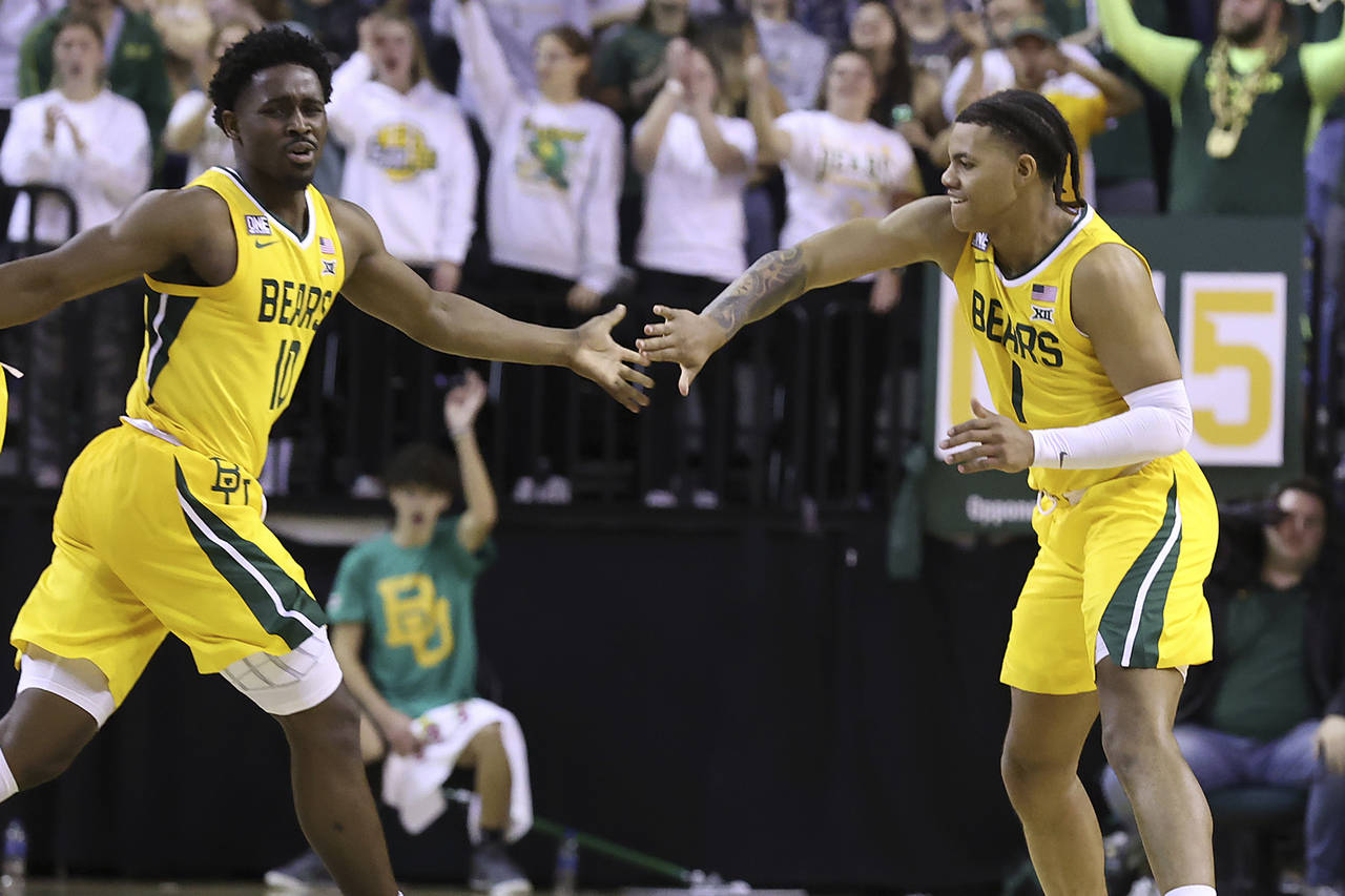 Baylor guard Adam Flagler, left, congratulates Baylor guard Keyonte George, right, after he made a ...