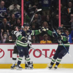 
              Vancouver Canucks' Elias Pettersson, left, and Ilya Mikheyev celebrate Pettersson's goal against the Los Angeles Kings during the second period of an NHL hockey game Friday, Nov. 18, 2022, in Vancouver, British Columbia. (Darryl Dyck/The Canadian Press via AP)
            