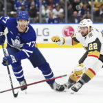 
              Toronto Maple Leafs forward Pierre Engvall (47) and Vegas Golden Knights forward Michael Amadio (22) chase the puck during the second period of an NHL hockey game, Tuesday, Nov. 8, 2022 in Toronto. (Nathan Denette/The Canadian Press via AP)
            