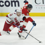 
              Carolina Hurricanes center Jesperi Kotkaniemi (82) and Florida Panthers defenseman Marc Staal (18) go after the puck during the first period of an NHL hockey game, Wednesday, Nov. 9, 2022, in Sunrise, Fla. (AP Photo/Marta Lavandier)
            
