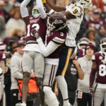 
              Mississippi State defensive backs including cornerback Decamerion Richardson (3) fight with East Tennessee State wide receiver Will Huzzie (9) for a pass during the first half of an NCAA college football game in Starkville, Miss., Saturday, Nov. 19, 2022. The pass fell incomplete. Mississippi State won 56-7. (AP Photo/Rogelio V. Solis)
            