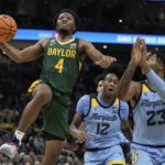 
              Baylor's LJ Cryer shoots past Marquette's David Joplin during the second half of an NCAA college basketball game Tuesday, Nov. 29, 2022, in Milwaukee. (AP Photo/Morry Gash)
            