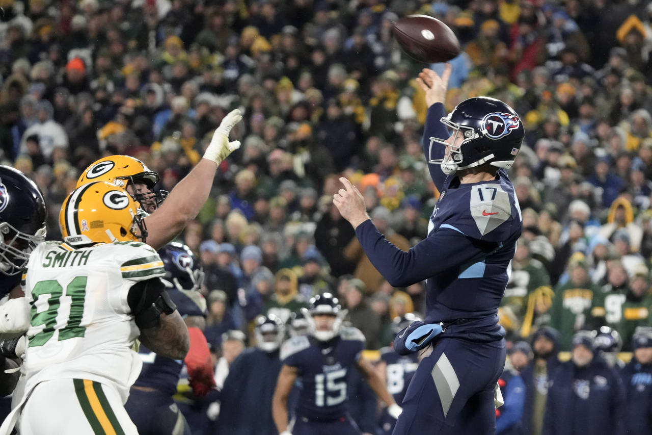 Tennessee Titans quarterback Ryan Tannehill (17) throws a pass under pressure from Green Bay Packer...