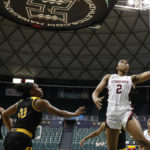 
              Stanford guard Agnes Emma-Nnopu (2) goes for a layup over Grambling State guard Leah Morrow and guard DeMya Young during the fourth quarter of an NCAA college basketball game, Saturday, Nov. 26, 2022, in Honolulu. (AP Photo/Marco Garcia)
            