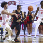 
              Dayton forward Mustapha Amzil (22) passes the ball in front of UNLV guard Justin Webster (2) during the first half of an NCAA college basketball game Tuesday, Nov. 15, 2022, in Las Vegas. (AP Photo/Chase Stevens)
            