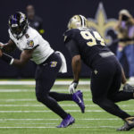 
              Baltimore Ravens quarterback Lamar Jackson (8) runs with the ball pursued by New Orleans Saints defensive end Cameron Jordan (94) nearby in the first half of an NFL football game in New Orleans, Monday, Nov. 7, 2022. (AP Photo/Butch Dill)
            