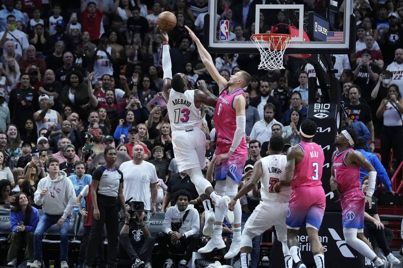 Miami Heat center Bam Adebayo (13) takes a shot against Washington Wizards center Kristaps Porzingi...