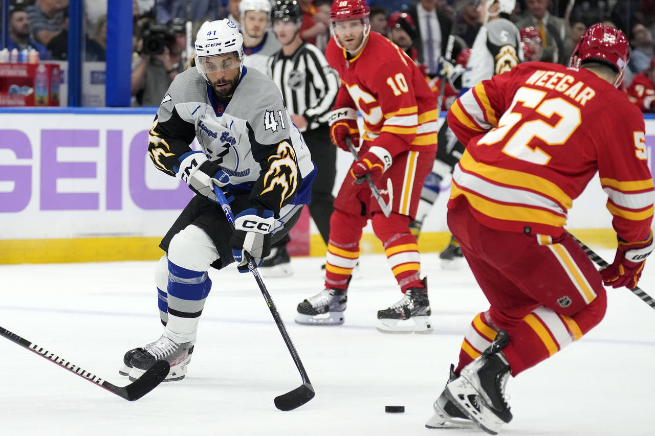 Tampa Bay Lightning left wing Pierre-Edouard Bellemare (41) loses the puck to Calgary Flames defens...