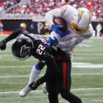 
              CORRECTS DATE TO SUNDAY, NOV. 6 INSTEAD OF TUESDAY, DEC. 6 - Los Angeles Chargers wide receiver DeAndre Carter (1) dives for extra yardage over Atlanta Falcons cornerback Cornell Armstrong (22) after catching a pass during the first half of an NFL football game, Sunday, Nov. 6, 2022, in Atlanta. (AP Photo/Butch Dill)
            