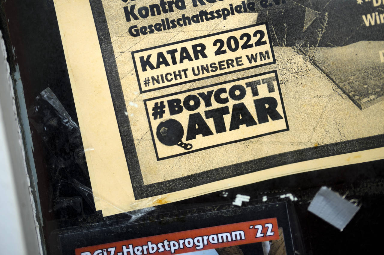 The slogans "Qatar 2022 not our World Cup" and "Boycott Qatar" are written on a flyer on the entran...