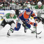 
              Dallas Stars' Nils Lundkvist (5) and Ryan Suter (20) battle for the puck against Edmonton Oilers' Zach Hyman (18) during second-period NHL hockey game action in Edmonton, Alberta, Saturday, Nov. 5, 2022. (Jason Franson/The Canadian Press via AP)
            