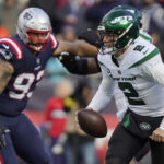 
              New York Jets quarterback Zach Wilson (2) runs under pressure from New England Patriots defensive end Lawrence Guy (93) during the first half of an NFL football game, Sunday, Nov. 20, 2022, in Foxborough, Mass. (AP Photo/Steven Senne)
            