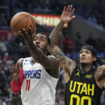
              Los Angeles Clippers guard John Wall, left, shoots as Utah Jazz guard Jordan Clarkson defends during the second half of an NBA basketball game Sunday, Nov. 6, 2022, in Los Angeles. (AP Photo/Mark J. Terrill)
            