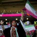 
              A soccer fan holds a flag from Iran prior to the World Cup group B soccer match between Wales and Iran, at the Ahmad Bin Ali Stadium in Al Rayyan , Qatar, Friday, Nov. 25, 2022. (AP Photo/Francisco Seco)
            