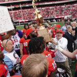
              Georgia head coach Kirby Smart and his player hoist the Governor's Cup after defeating Georgia Tech in an NCAA college football game Saturday, Nov. 26, 2022 in Athens, Ga. (AP Photo/John Bazemore)
            