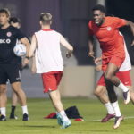 
              Canada star Alphonso Davies, right, grimaces during a training session at the World Cup soccer tournament in Doha, Qatar Monday, Nov. 21, 2022.  (Nathan Denette/The Canadian Press via AP)
            