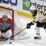 
              Boston Bruins' Hampus Lindholm (27) tries to score on Florida Panthers' goalie Spencer Knight during the first period of an NHL hockey game, Wednesday, Nov. 23, 2022, in Sunrise, Fla. (AP Photo/Michael Laughlin)
            