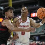 
              Wisconsin's Jahcobi Neath shoots past Stanford's Spencer Jones during the first half of an NCAA college basketball game Friday, Nov. 11, 2022, in Milwaukee. The game is being played at American Family Field, home of the Milwaukee Brewers. (AP Photo/Morry Gash)
            